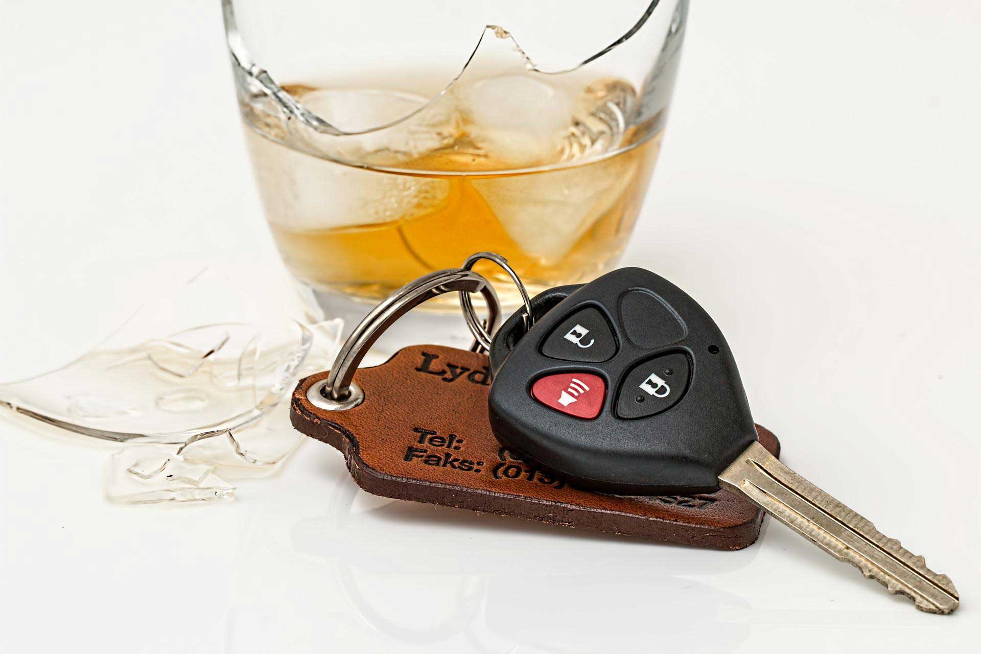 a key and a glass of alcoholic drink