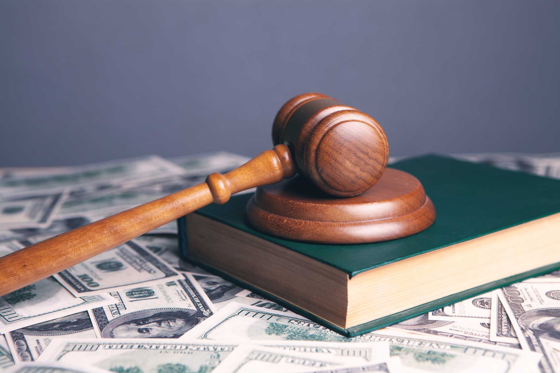 a wooden gavel on top of a green book